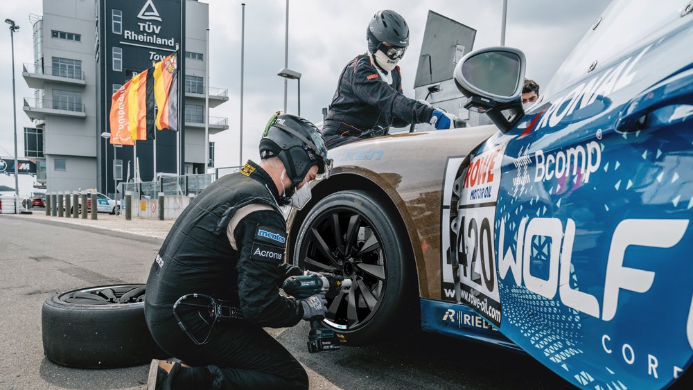 people fixing a racing car