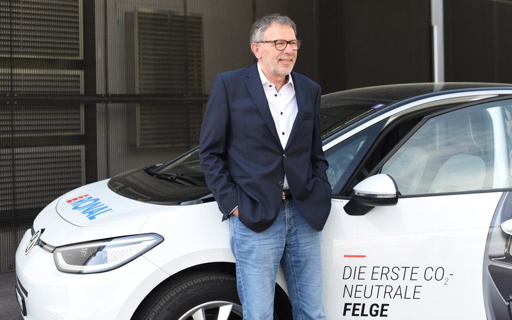 Martin Wyss in front of a white car