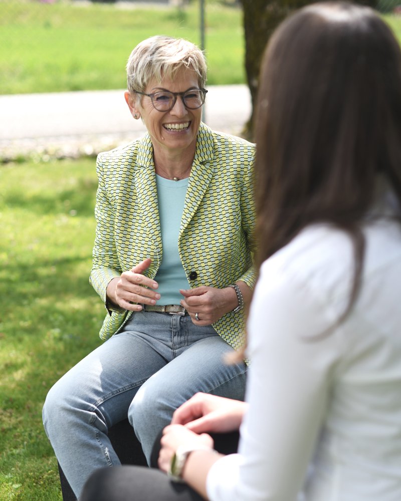 a woman with glasses smiling