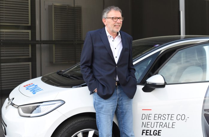 Martin Wyss in front of a white car